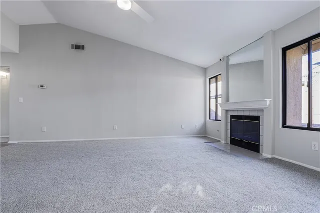 a view of empty room with a fireplace