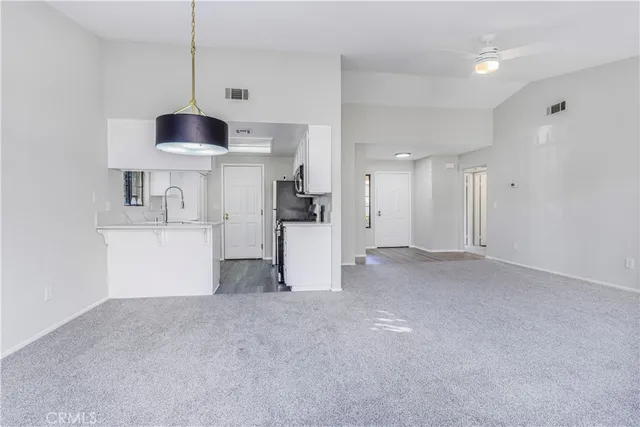 a view of a kitchen with a sink and a refrigerator