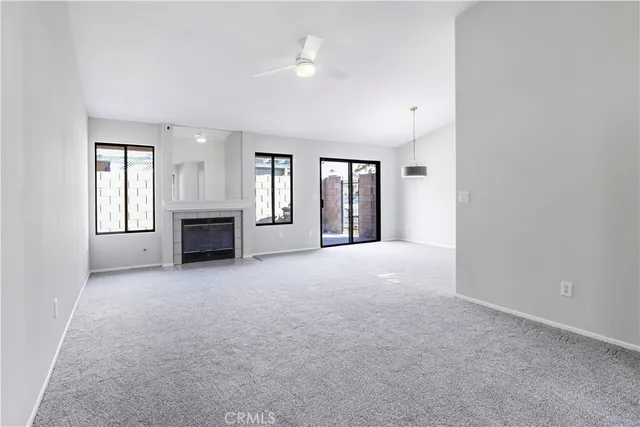 an empty room with furniture and a fireplace