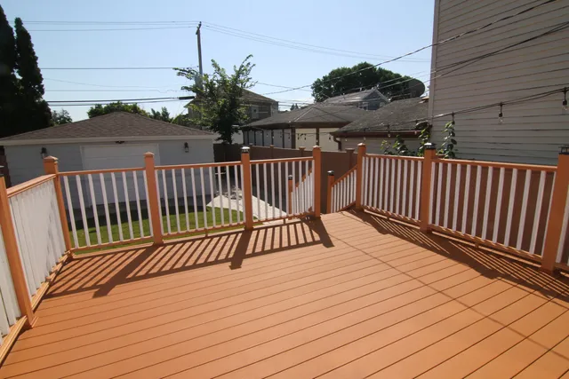 a view of a brick house with wooden fence