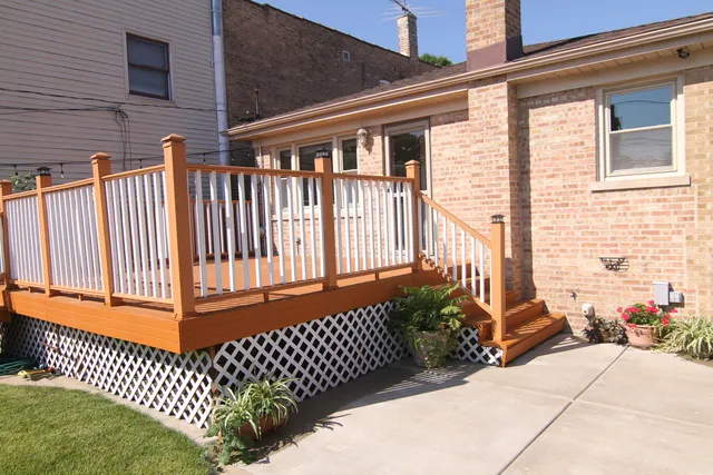 a backyard of a house with a table and chairs