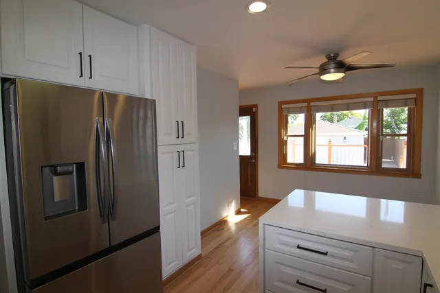 a kitchen with a refrigerator and a sink