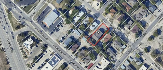 a view of a room with wooden floor and a ceiling fan