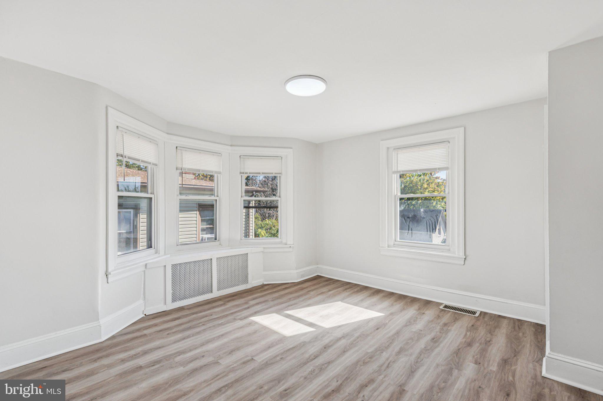 3408 Marshall Road Drexel Hill, PA 19026 - Photo 12 of 28 an empty room with wooden floor and windows