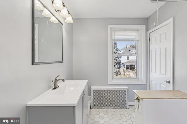 a bathroom with a sink a toilet and mirror