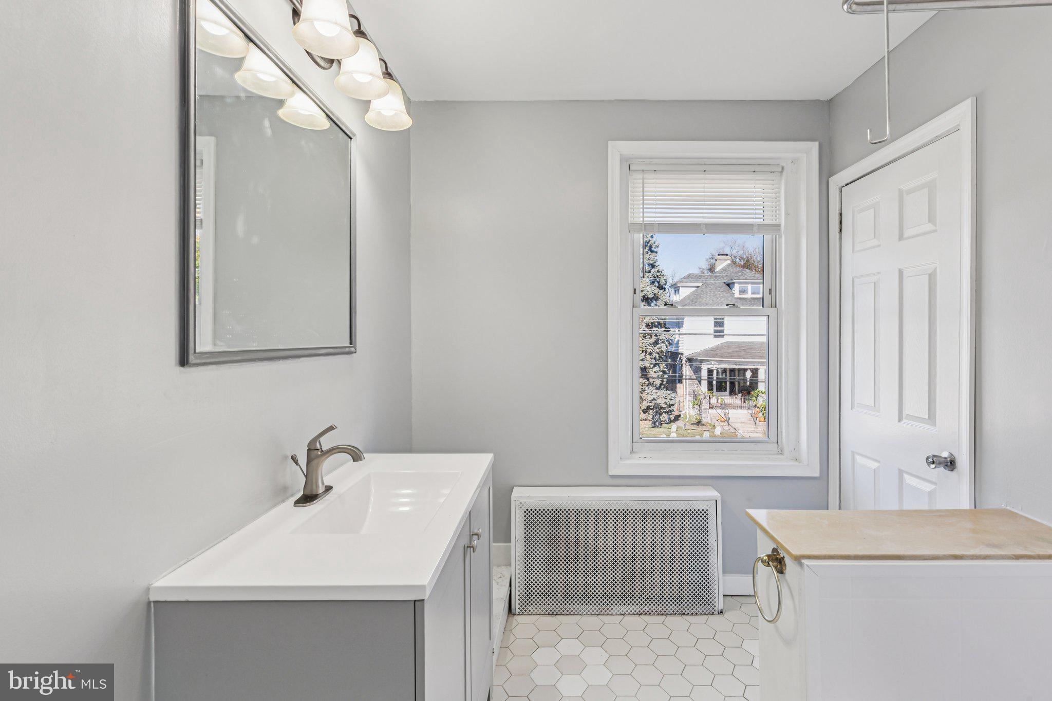 3408 Marshall Road Drexel Hill, PA 19026 - Photo 13 of 28 a bathroom with a sink a toilet and mirror