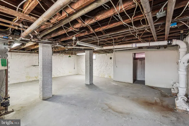 a view of a room with wooden floor and white walls
