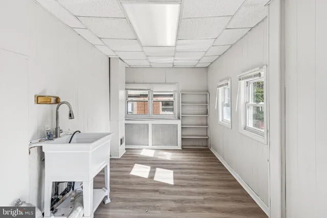 a spacious bathroom with a granite countertop sink and a mirror