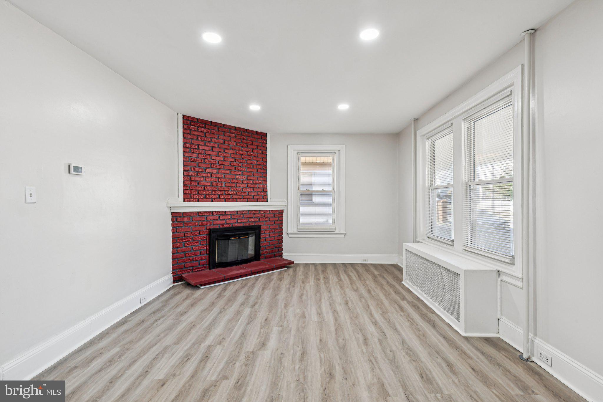 3408 Marshall Road Drexel Hill, PA 19026 - Photo 27 of 28 a view of an empty room with a fireplace and a window