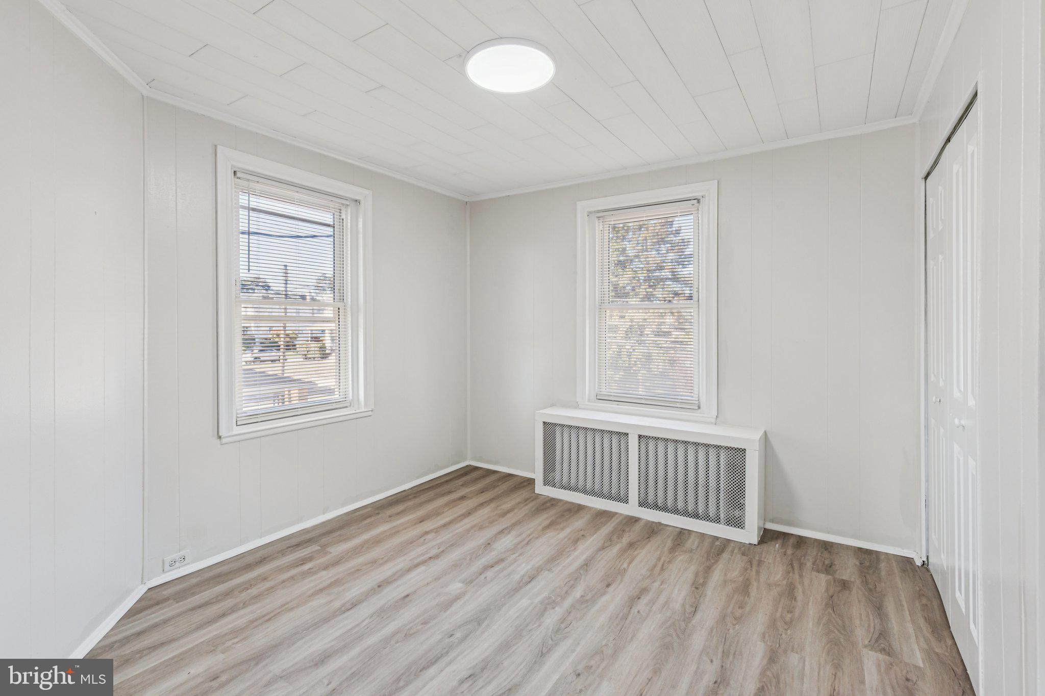 3408 Marshall Road Drexel Hill, PA 19026 - Photo 8 of 28 a view of an empty room with a window and wooden floor