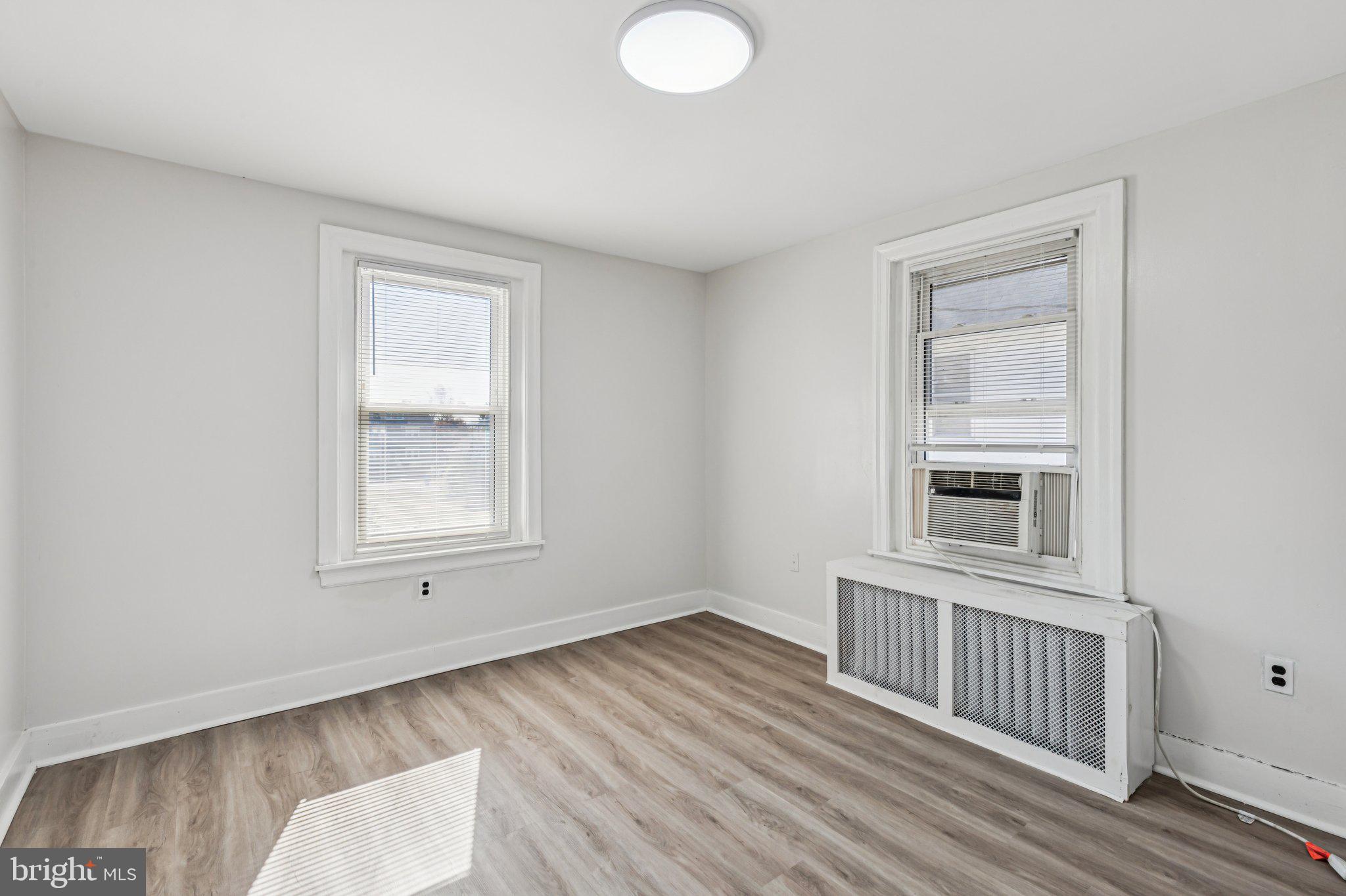 3408 Marshall Road Drexel Hill, PA 19026 - Photo 10 of 28 an empty room with wooden floor and windows