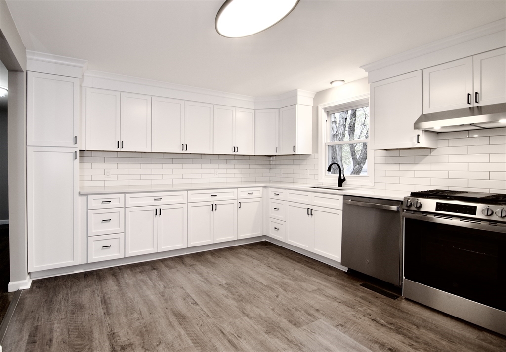 68 Sunrise Terrace Springfield, MA 01119 - Photo 14 of 42 a kitchen with granite countertop white cabinets and white appliances