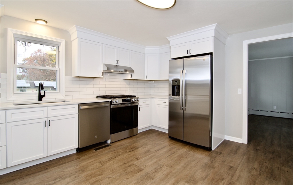 68 Sunrise Terrace Springfield, MA 01119 - Photo 17 of 42 a kitchen with a refrigerator sink and wooden floor