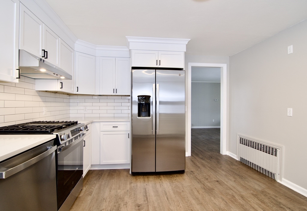 68 Sunrise Terrace Springfield, MA 01119 - Photo 18 of 42 a kitchen with a refrigerator sink and wooden floor