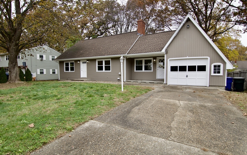 68 Sunrise Terrace Springfield, MA 01119 - Photo 2 of 42 a front view of a house with a yard and garage