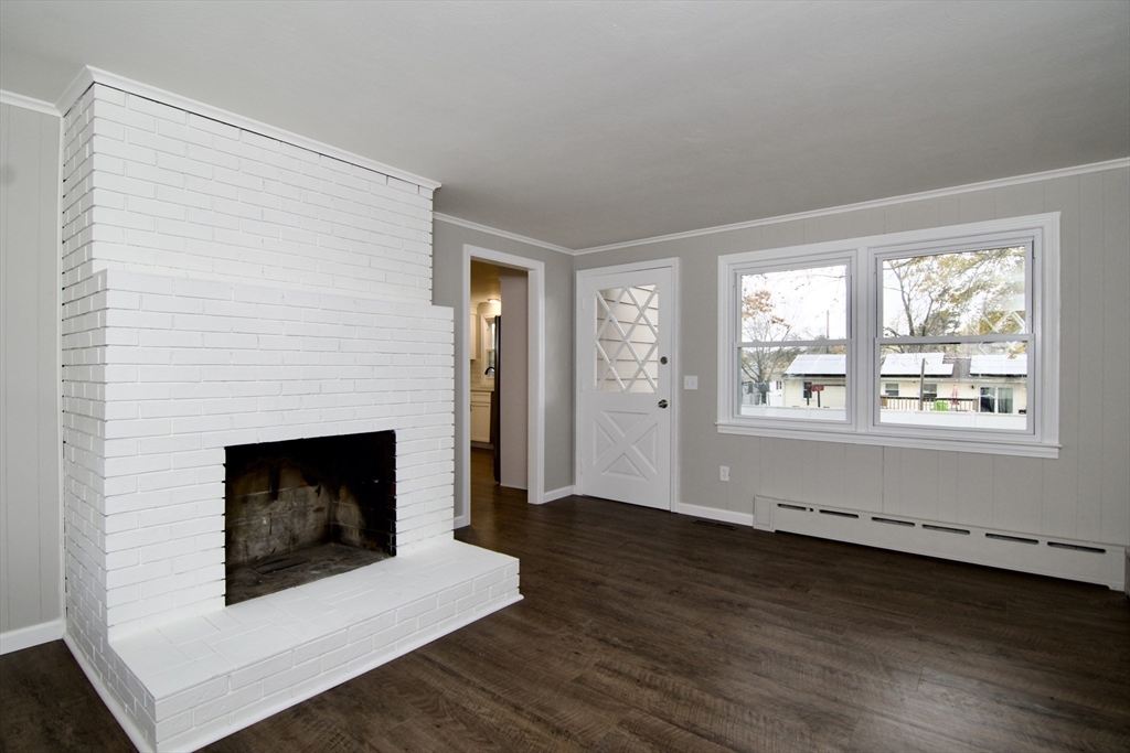 68 Sunrise Terrace Springfield, MA 01119 - Photo 22 of 42 a living room with wooden floor and a fireplace