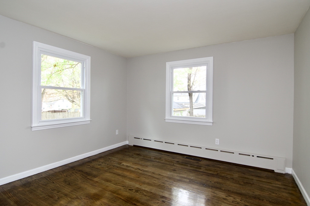 68 Sunrise Terrace Springfield, MA 01119 - Photo 23 of 42 a view of an empty room with wooden floor and a window
