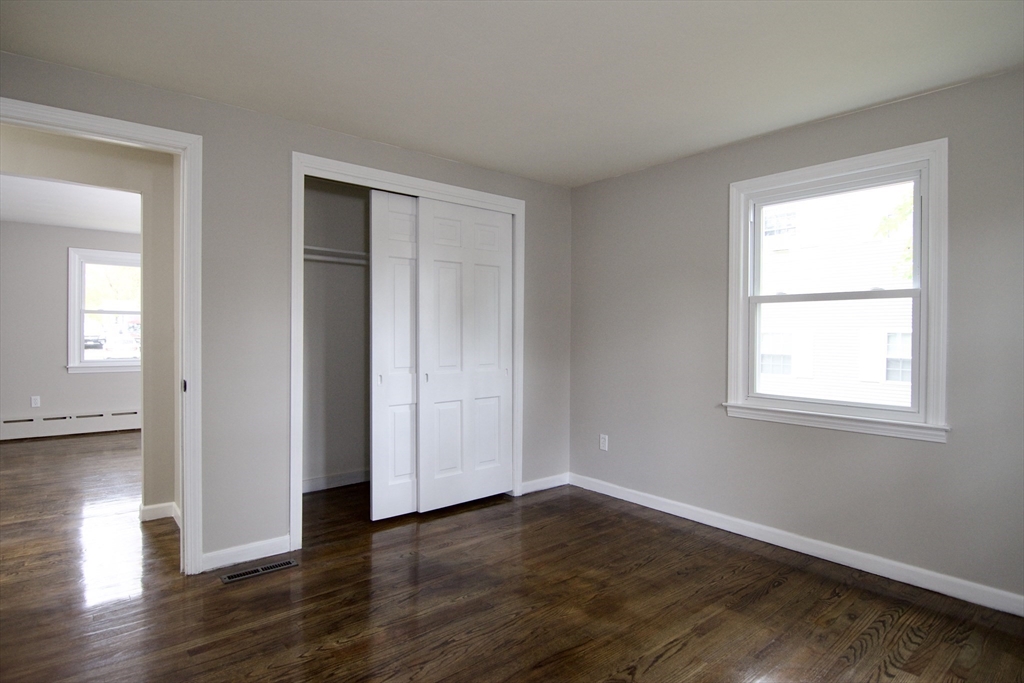 68 Sunrise Terrace Springfield, MA 01119 - Photo 25 of 42 a view of an empty room with wooden floor and a window