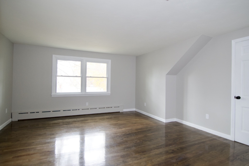 68 Sunrise Terrace Springfield, MA 01119 - Photo 27 of 42 an empty room with wooden floor and windows