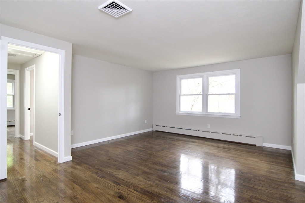 68 Sunrise Terrace Springfield, MA 01119 - Photo 31 of 42 an empty room with wooden floor and windows