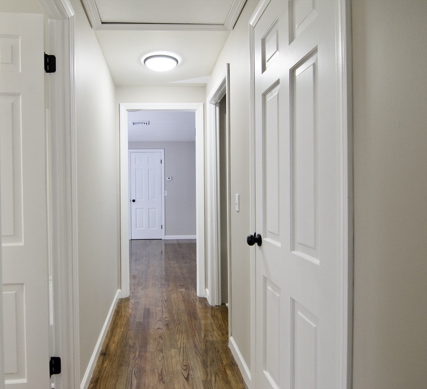 68 Sunrise Terrace Springfield, MA 01119 - Photo 32 of 42 a view of a hallway with wooden floor and closet area
