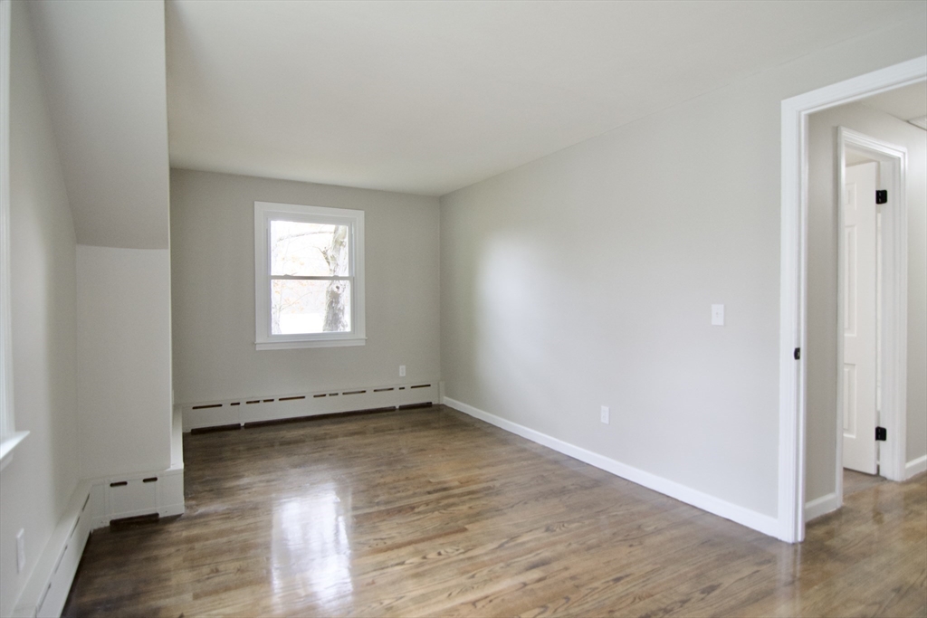 68 Sunrise Terrace Springfield, MA 01119 - Photo 37 of 42 an empty room with wooden floor and windows