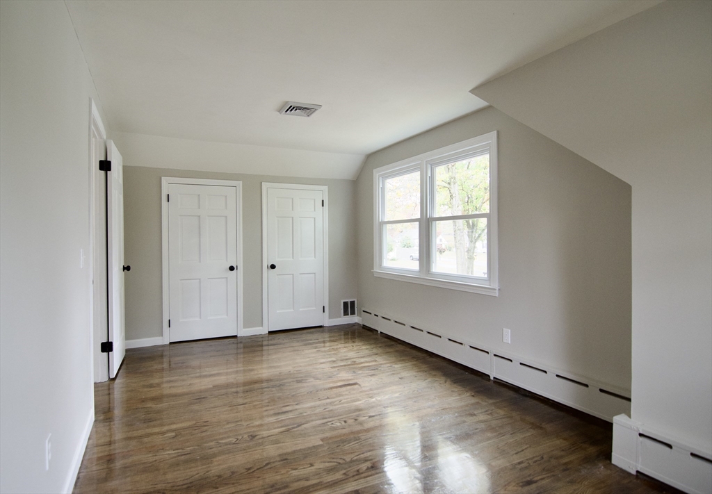 68 Sunrise Terrace Springfield, MA 01119 - Photo 39 of 42 a view of an empty room with wooden floor and a window