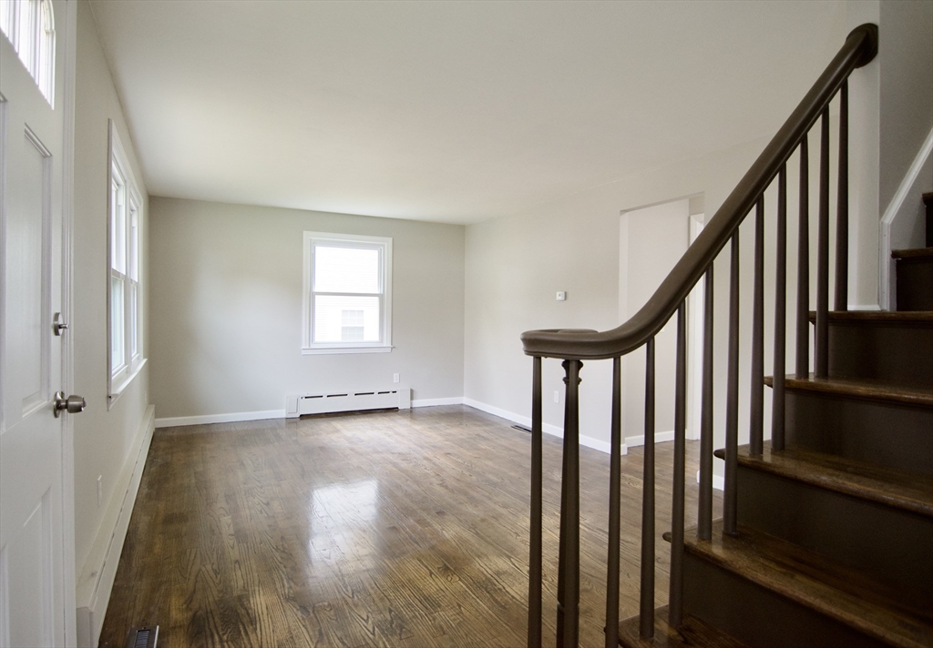68 Sunrise Terrace Springfield, MA 01119 - Photo 5 of 42 a view of an empty room with wooden floor and stairs
