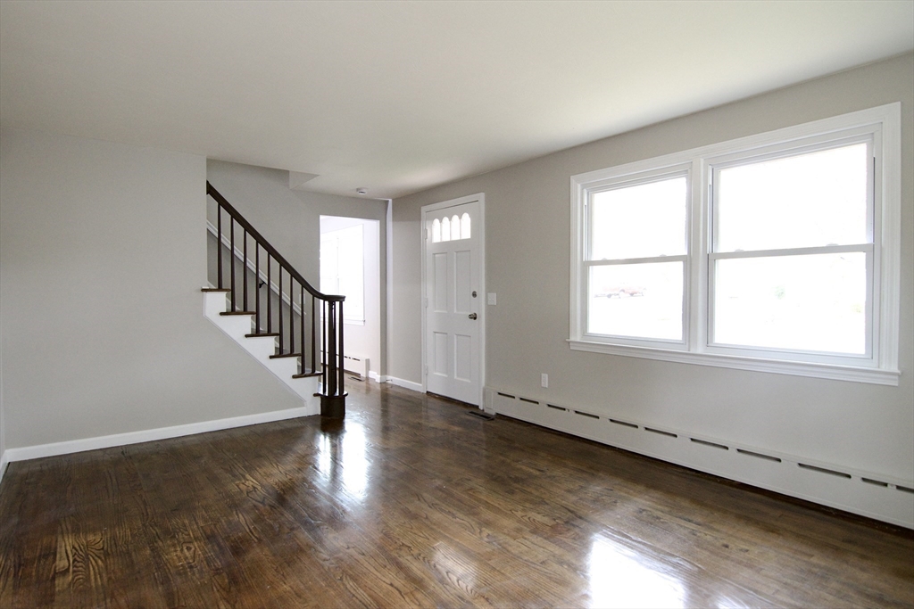 68 Sunrise Terrace Springfield, MA 01119 - Photo 6 of 42 a view of an empty room with wooden floor and a window