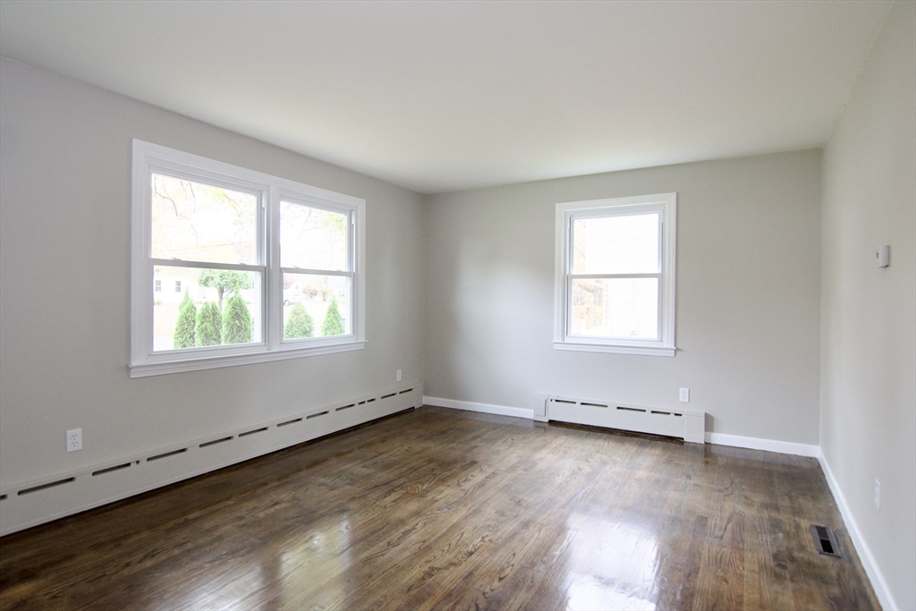 68 Sunrise Terrace Springfield, MA 01119 - Photo 7 of 42 an empty room with wooden floor and windows