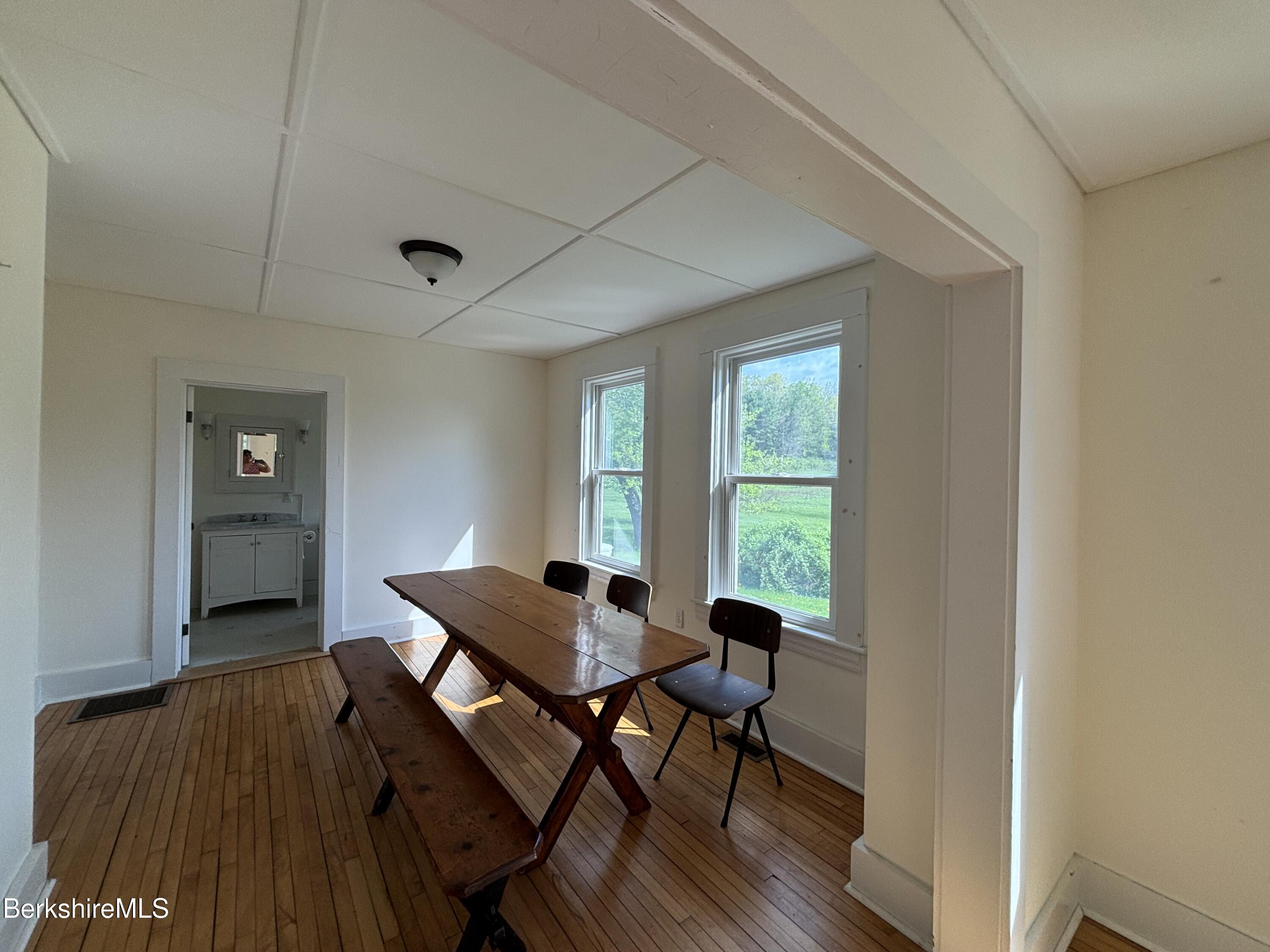 86 Miner Road Lanesborough, MA 01237 - Photo 31 of 44 a view of a dining room with furniture window and wooden floor