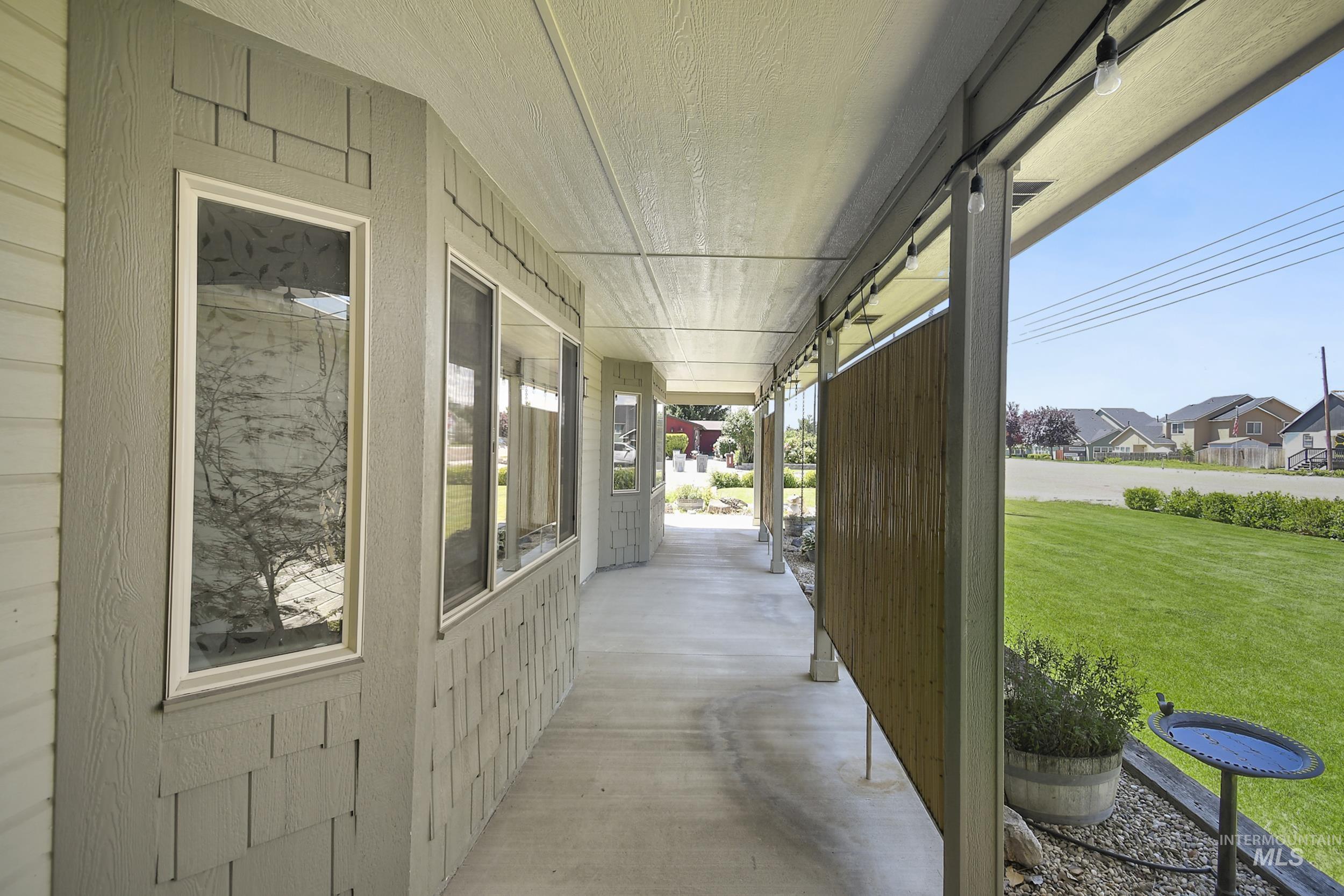 1108 East Ustick Road Caldwell, ID 83607 - Photo 5 of 30 Covered concrete porch with light gray siding and shake accents