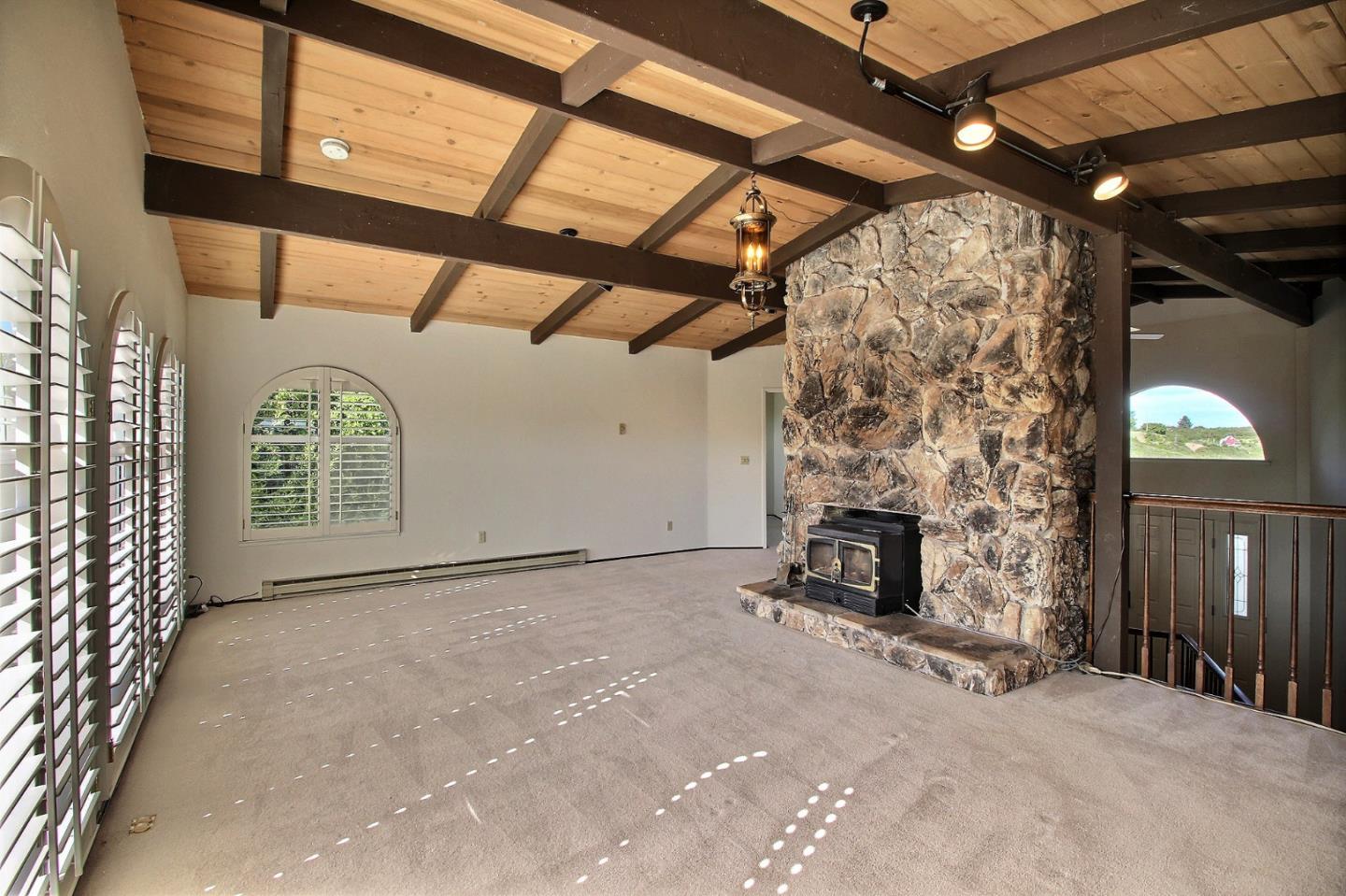 16999 McGill Road Saratoga, CA 95070 - Photo 12 of 41 a view of empty room with fireplace and windows