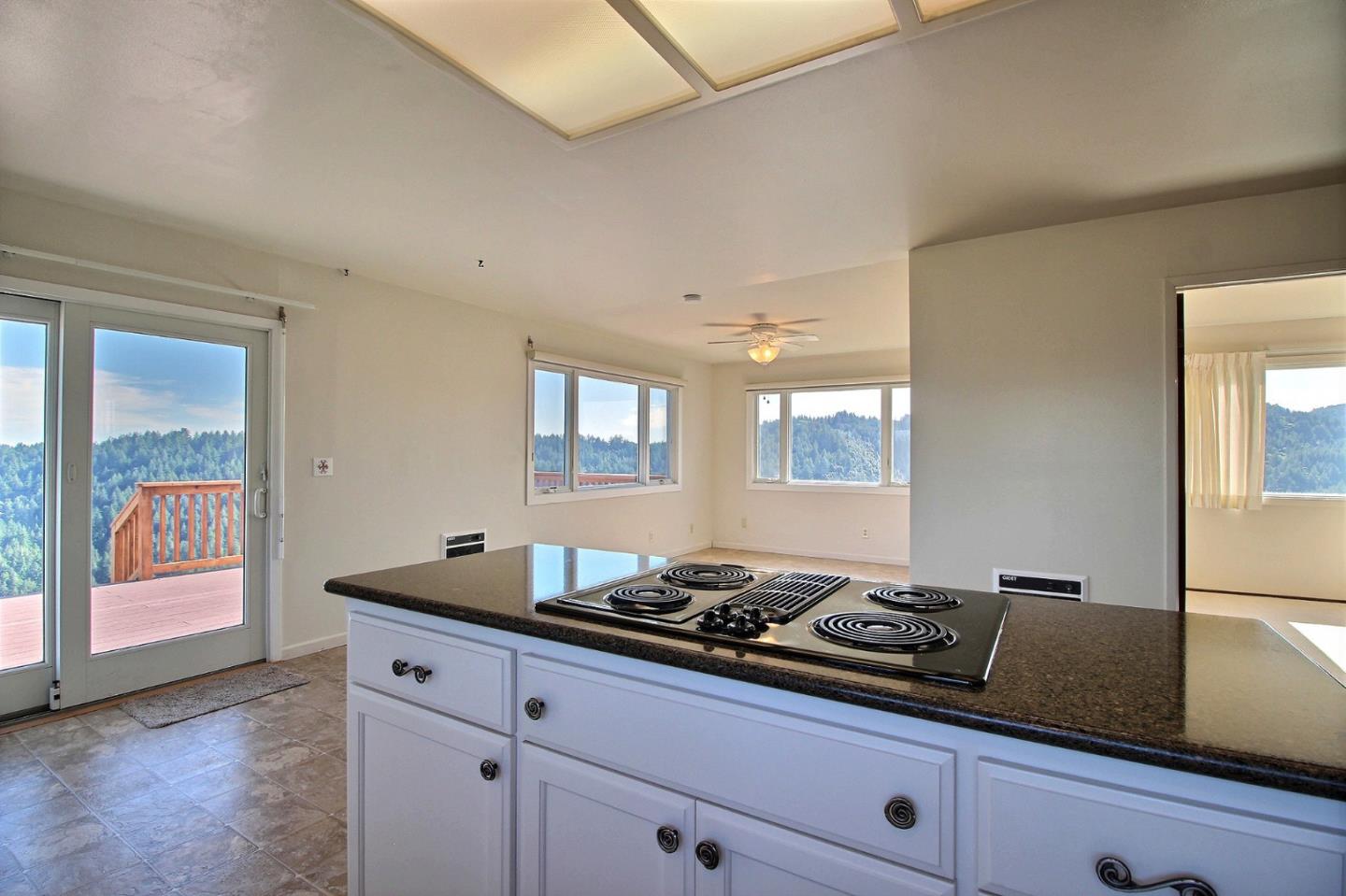 16999 McGill Road Saratoga, CA 95070 - Photo 13 of 41 a kitchen with granite countertop a sink cabinets and window