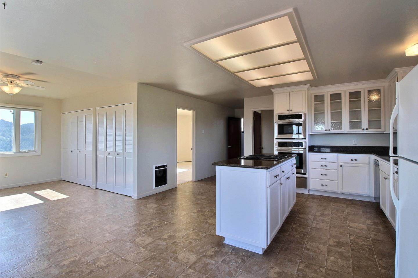 16999 McGill Road Saratoga, CA 95070 - Photo 14 of 41 a kitchen with stainless steel appliances granite countertop a stove and a refrigerator