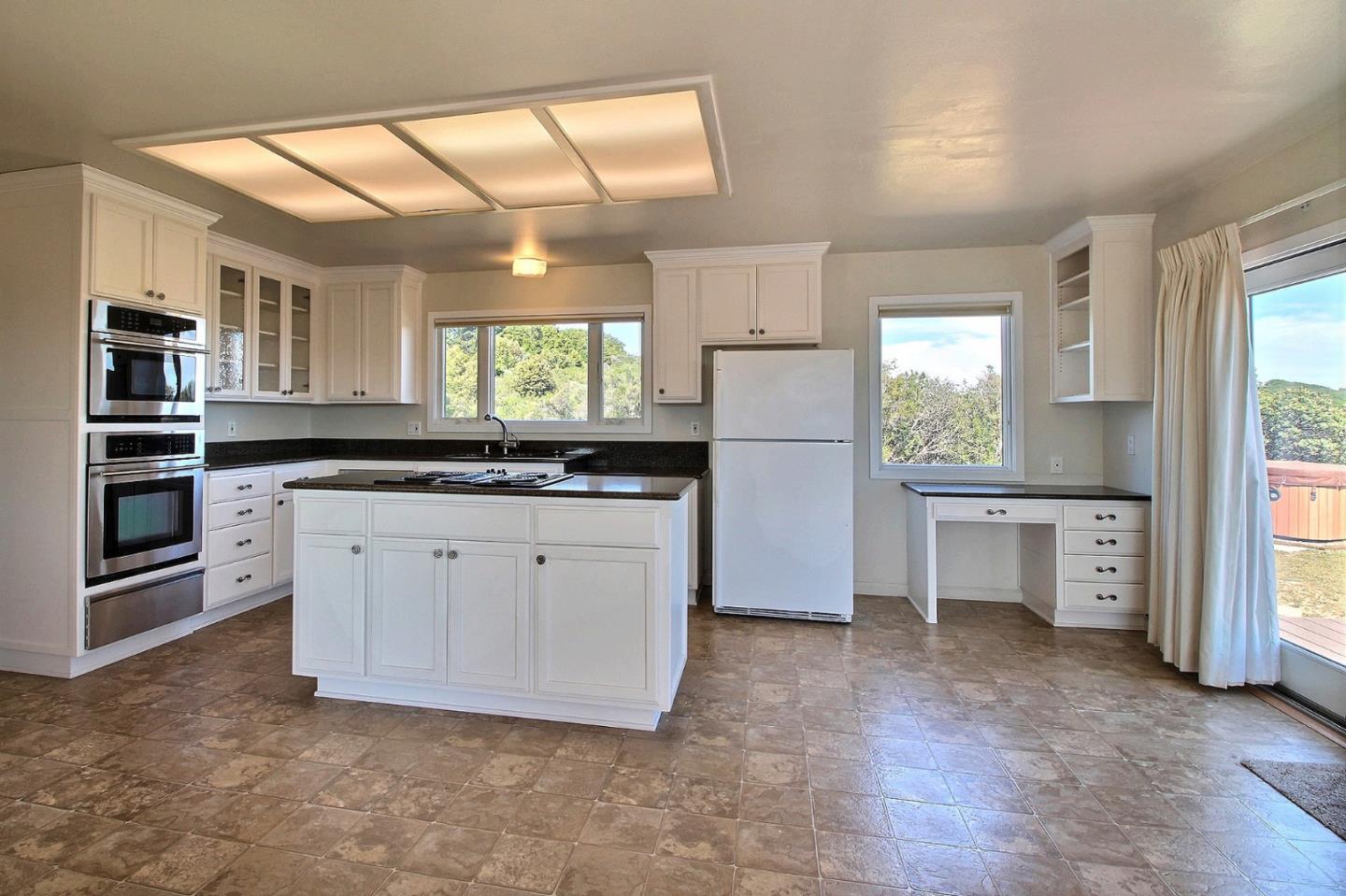 16999 McGill Road Saratoga, CA 95070 - Photo 16 of 41 a kitchen with granite countertop a stove a sink and a refrigerator