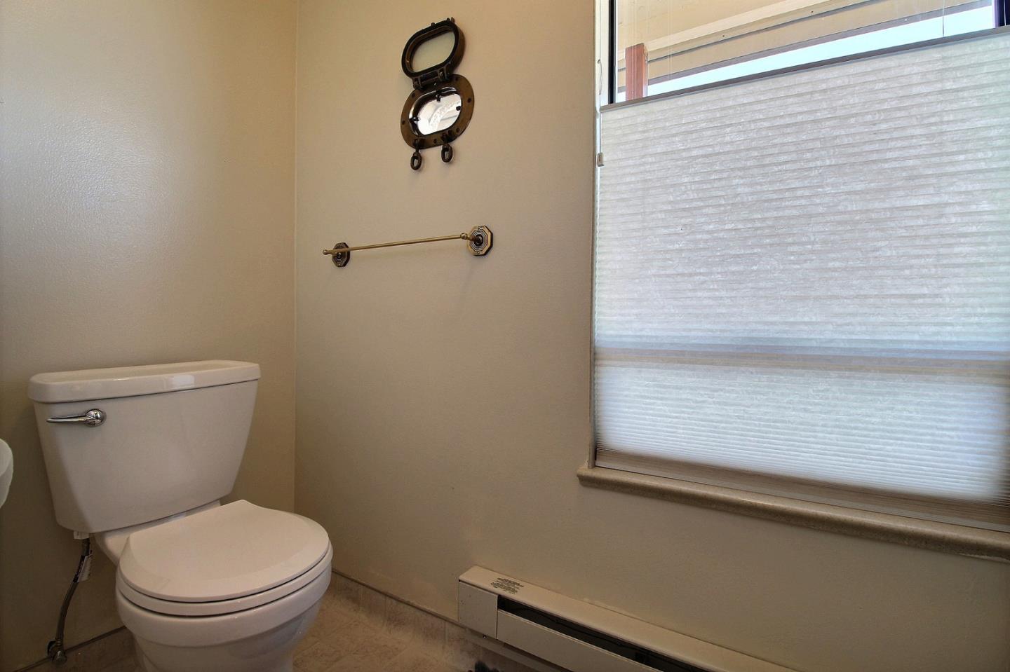 16999 McGill Road Saratoga, CA 95070 - Photo 24 of 41 a white toilet sitting next to a window