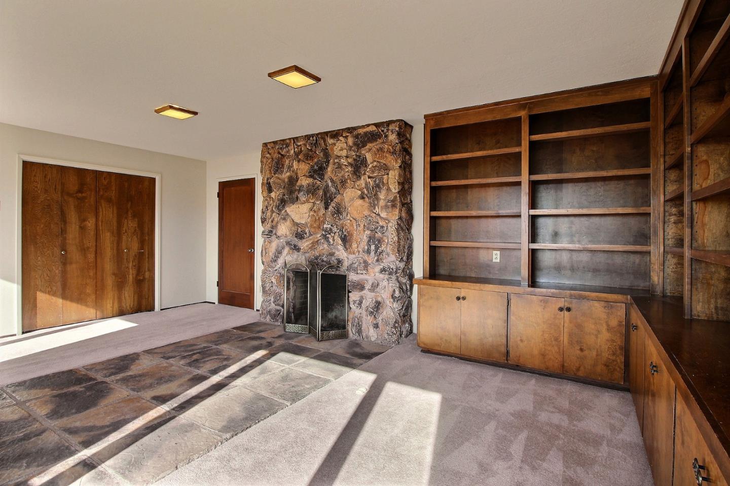 16999 McGill Road Saratoga, CA 95070 - Photo 26 of 41 a living room with furniture and a fireplace