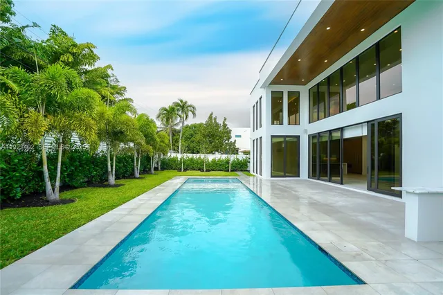 a kitchen with stainless steel appliances a sink a stove and a wooden floor
