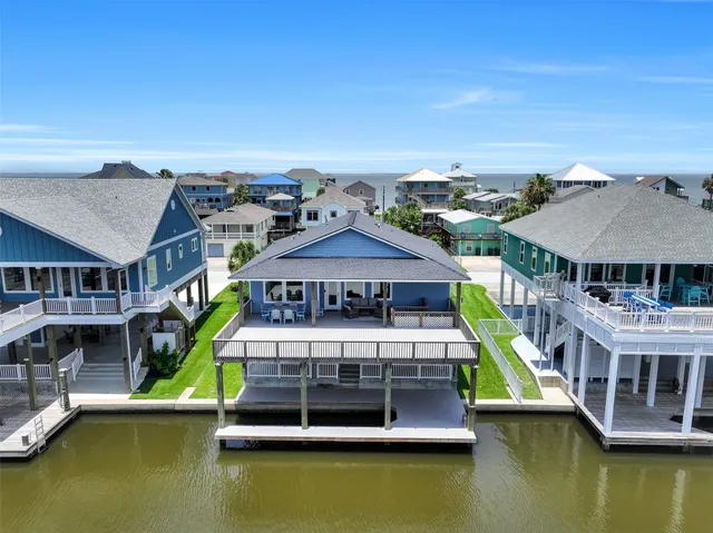 an aerial view of a house with swimming pool patio and outdoor seating