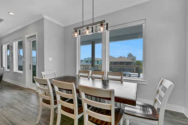 a living room with furniture kitchen view and a chandelier