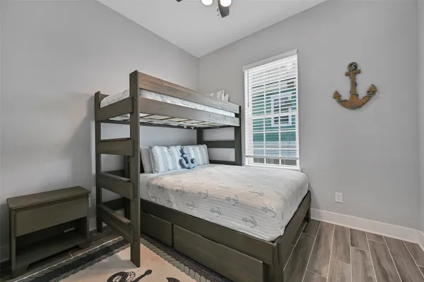 a bedroom with a bed and a wooden floor
