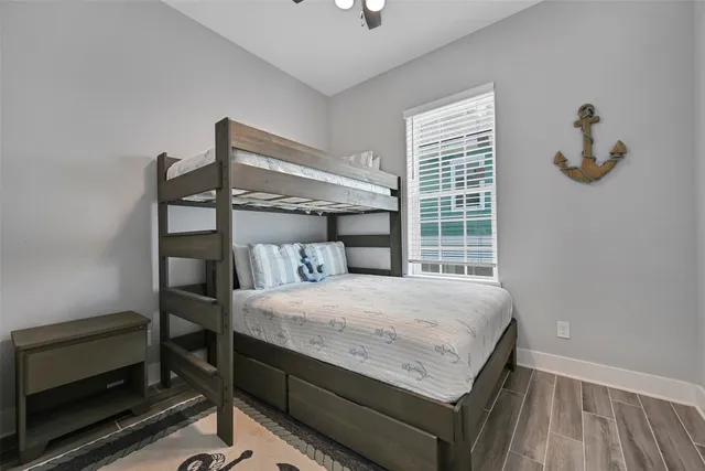 a bedroom with a bed and a wooden floor