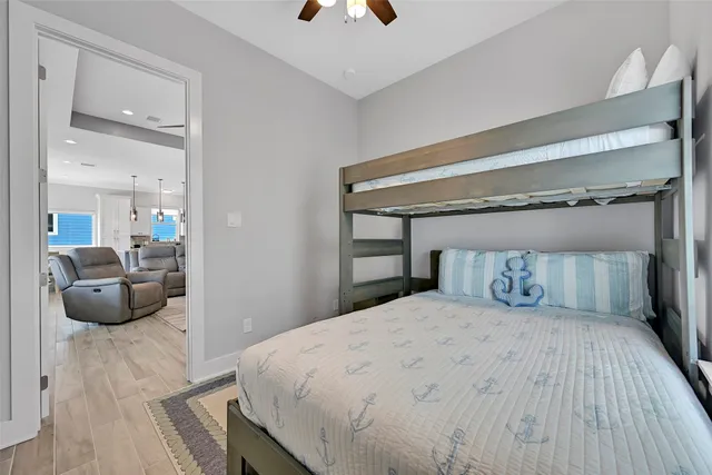 a bathroom with a sink a toilet a large mirror and shower