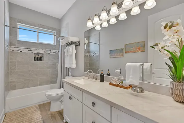 a bathroom with a toilet sink and shower
