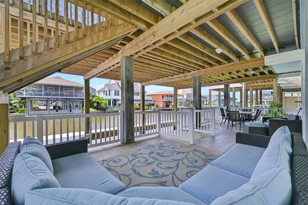 a view of a patio with table and chairs with wooden floor and fence