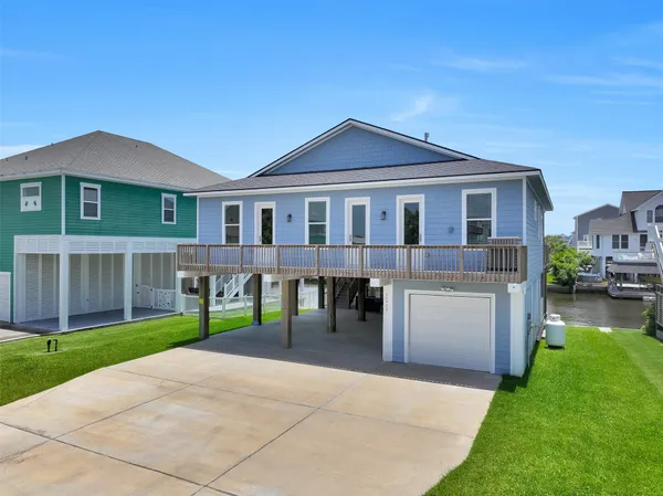 a view of a house with a yard and sitting area