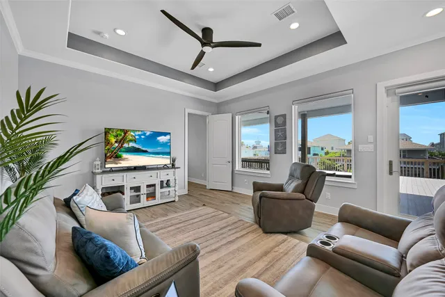 a kitchen with kitchen island granite countertop a table chairs stainless steel appliances and wooden floor