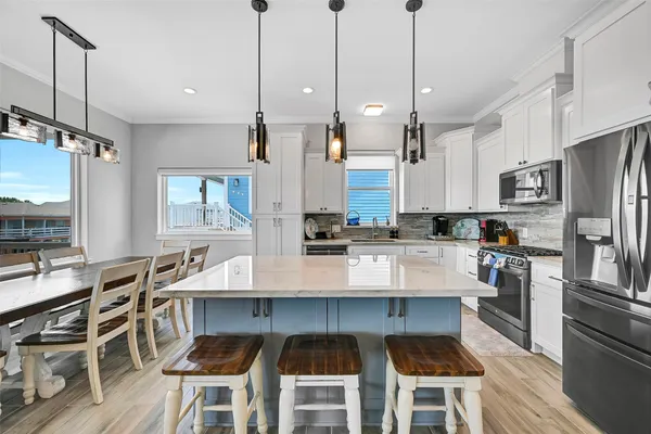 a kitchen with stainless steel appliances a refrigerator sink and microwave
