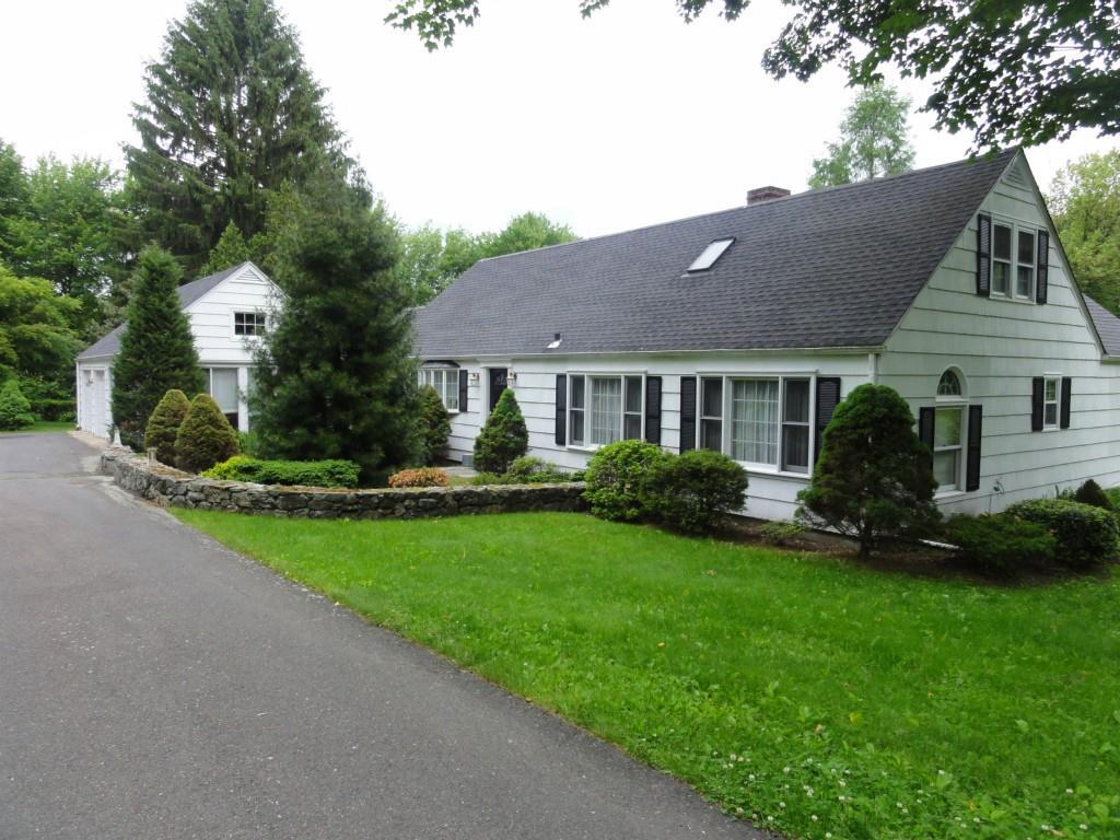 24 Porter Hill Road Middlebury, CT 06762 - Photo 1 of 1 a front view of a house with a yard and trees